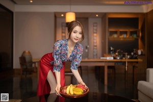 A woman sitting at a table with a plate of food.