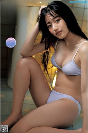 A poster of a young woman in a red and white checkered bikini.