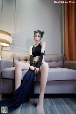 A woman sitting on a couch in a living room.