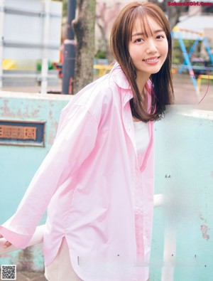 A woman in a white dress posing for a magazine.