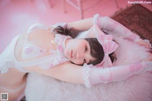 A woman in a white lingerie with horns on her head.