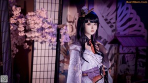 A woman in a kimono is posing for a picture.